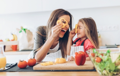 Happy woman and girl in the kitchen